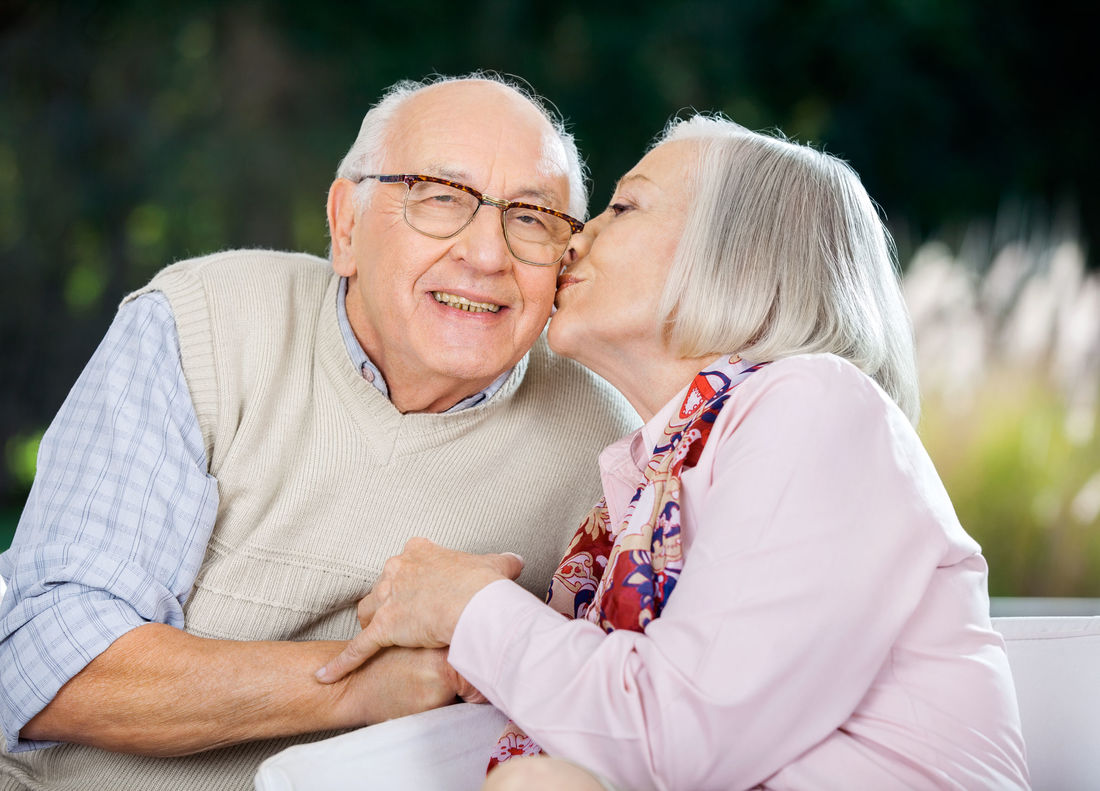 35442432 - senior woman kissing on mans cheek